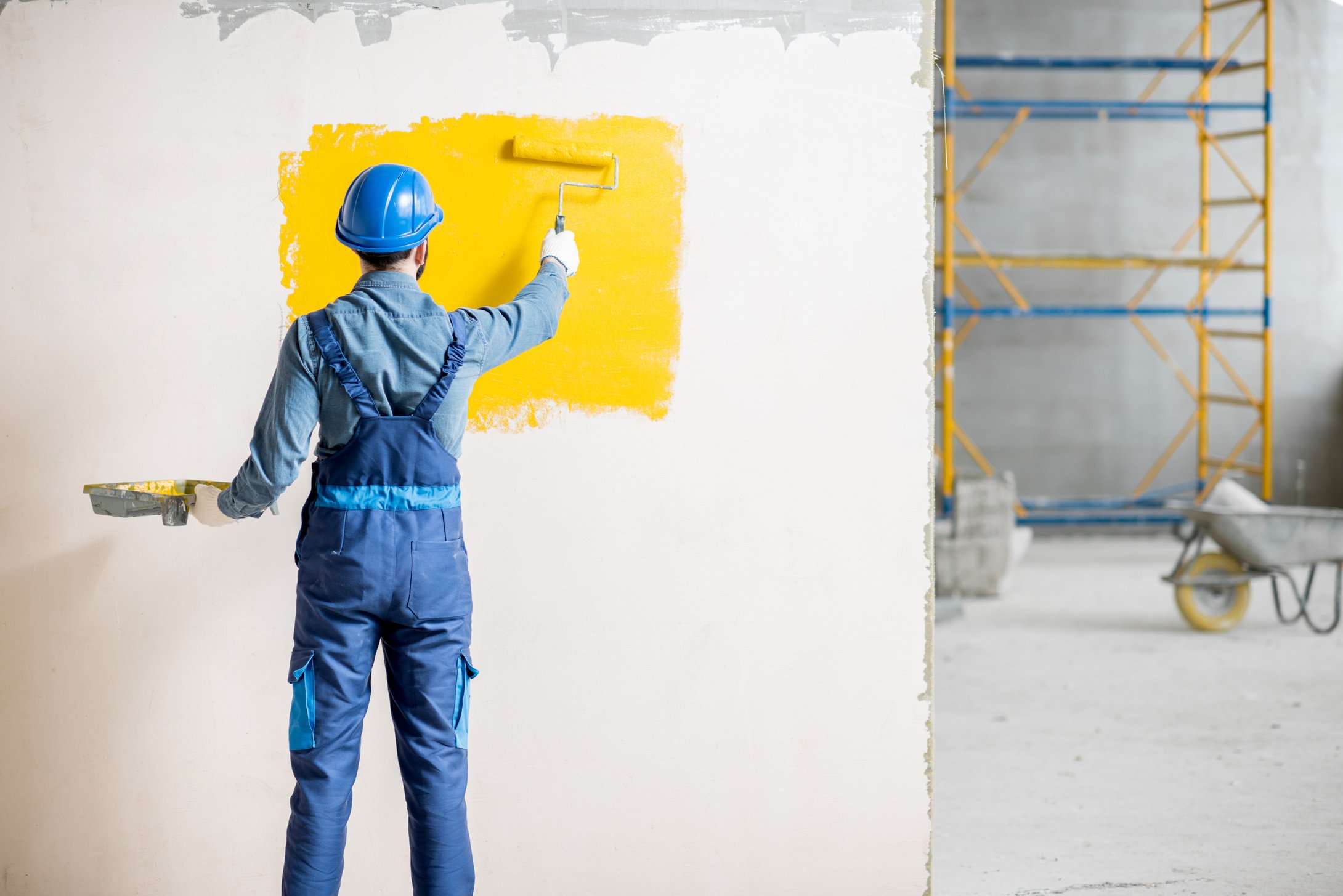 Workman Painting Wall Indoors